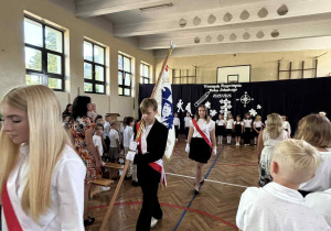 Uczniowie wyprowadzają sztandar szkoły.